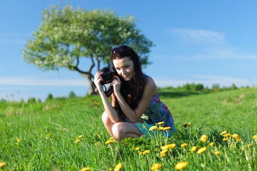woman photographer on green grass field