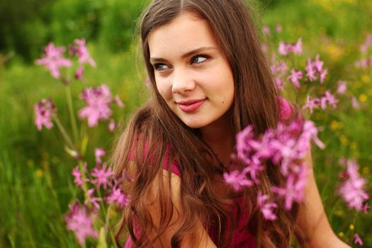 woman on pink flower field close portrait