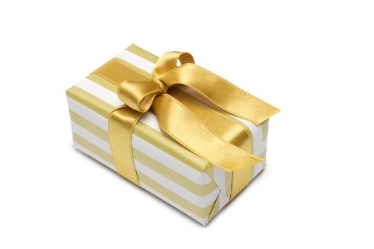 Gift box in gold duo tone with golden satin ribbon and bow isolated over white background.