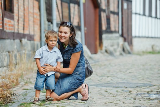 Mother and her little son outdoors in city