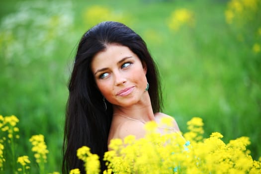 woman on oilseed field close portrait