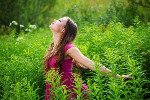 woman on green grass field close portrait