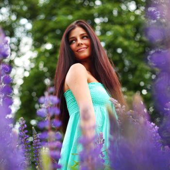 woman on pink flower field close portrait