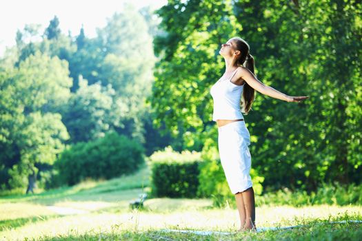 yoga woman on green park background