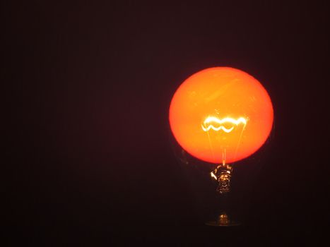 A metaphorical image of a light bulb powered by the Sun's light.                               