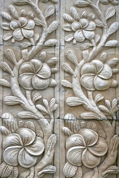 flower shape stone carving on wall in bali style