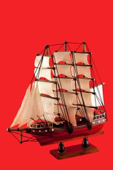 isolated model of luxury sailboat on red background