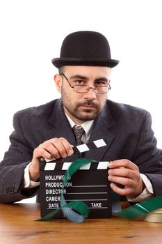 Old fashioned man holding movie clapboard 