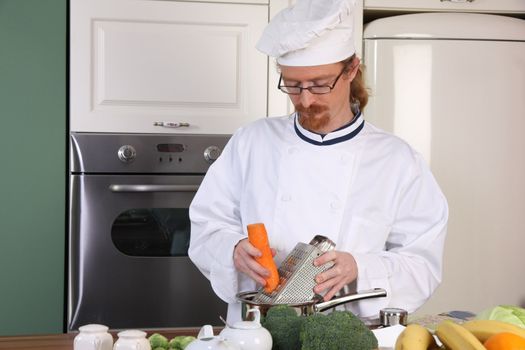 Young chef with vegetables, preparing lunch in kitchen