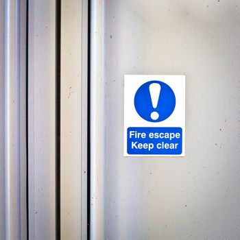 Fire escape sign on a modern door panel