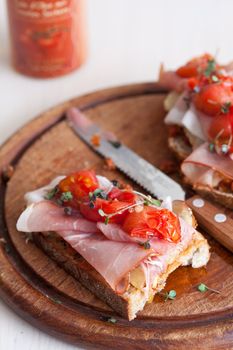 Bruschetta with ham, tomatoes on toast