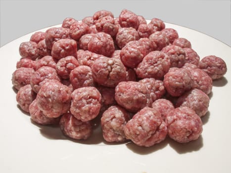 small meatballs for the soup on a white plate