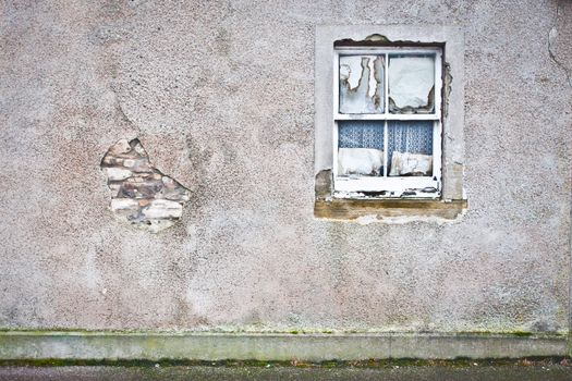 Rotten window pane in a derelict house