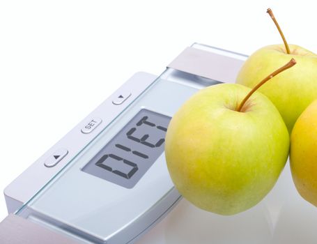 Diet - Green Apples on Bathroom Scales With Diet Sign on Display on White Background