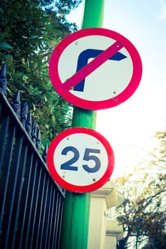 Road sign indicating 25 mph speed limit and "do not turn right"