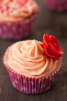 Close up of birthday cupcake decorated with rose of marzipan