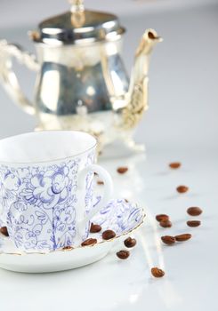 close up of a coffee cup with coffe beans