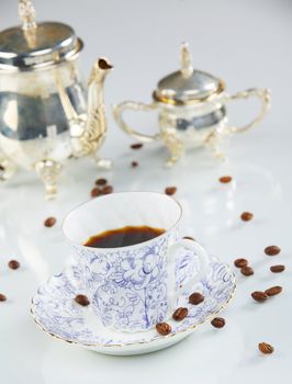 close up of a coffee cup with coffe beans