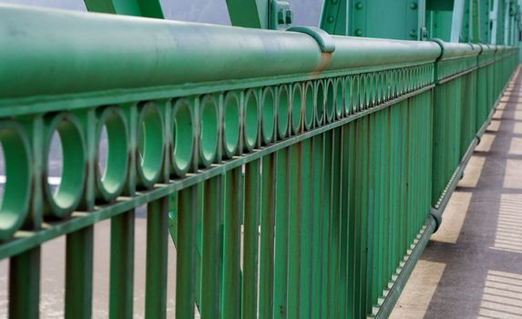 Green Railing in perspective on diminshing to soft focus