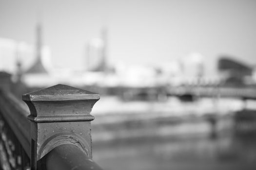 Sharp image of bridge railin post with very soft image of Portland in background