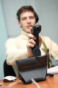 Call center operator answering a call, focus on the receiver