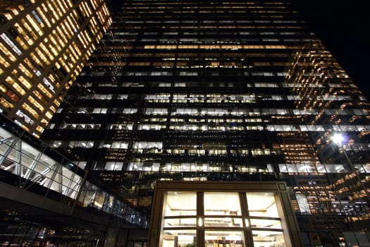 Glass facade of an office building by late night