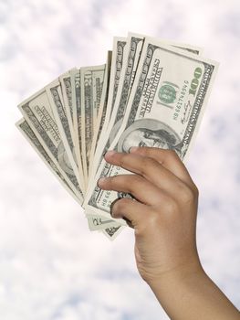 hand holding up dollar bills
