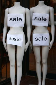 Sale signs on mannequins