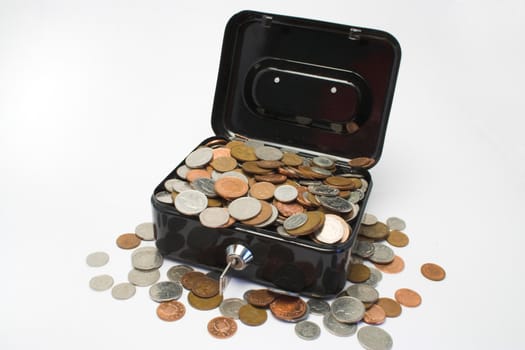 A metal box with a key,full of coins