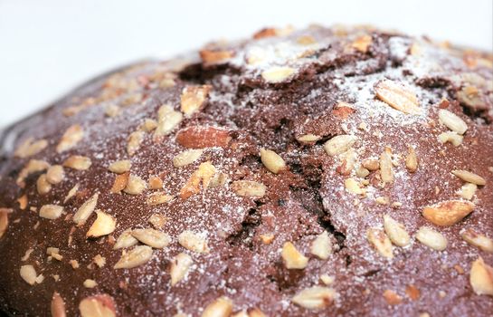 Chocolate cake with nuts and seeds close up
