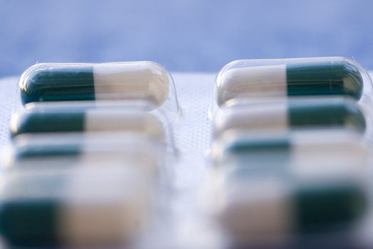 Set of pills/antibiotics with blurred blue backgound