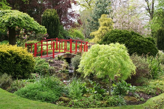 A bridge over a pond in a beautiful English garden