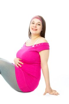 portrait of a happy beautiful pregnant woman sitting on the floor