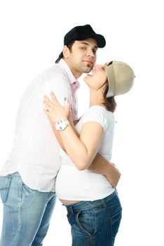 happy family, young beautiful pregnant woman and her husband embracing and kissing