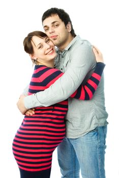 happy family, beautiful young pregnant woman and her husband embracing