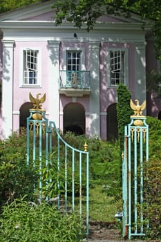 Elaborate gates invite you into the pink house