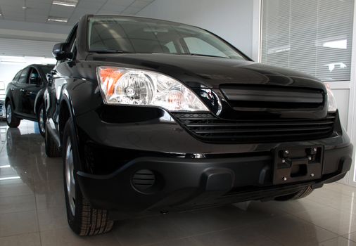 Black car standing on exhibition for sale