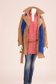 Mannequin dressed with a scarf, jacket, blouse and jeans