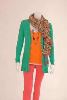 Mannequin dressed with a scarf, jacket, shirt and green pants