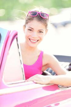 Woman in vintage car. Happy smiling retro woman in pink old retro car. From Havana, Cuba.