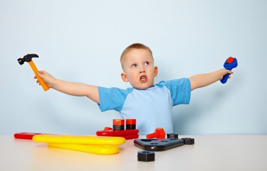 Emotional child plays at the table