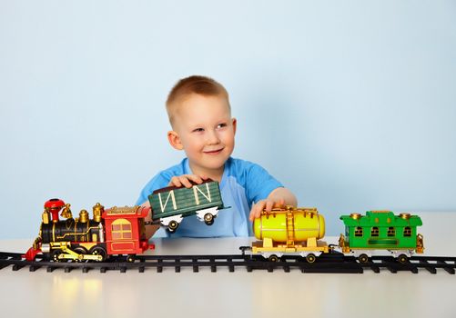 Boy playing with toy railroad at table