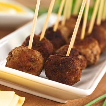 Meatball appetizers with toothpicks (Selective Focus, Focus on the first two meatballs)