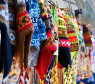 A row of colorful Alpaca wool knit hats in a row at a market