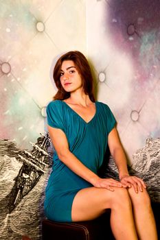 View of a beautiful young girl on a blue dress inside a bar pub.