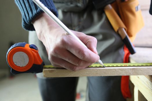 Carpenter marking a piece of wood