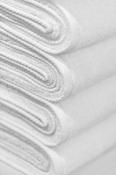 A stack of new white towels close-up - the background