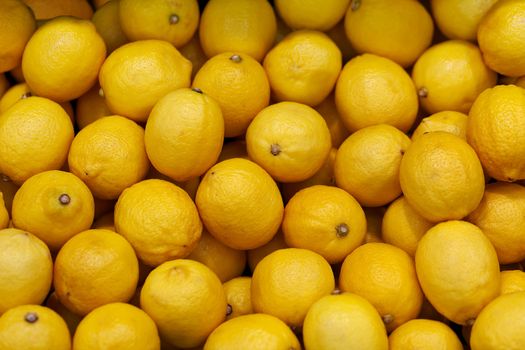 Yellow lemons on the market counter - fruit background