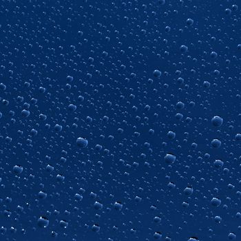 The texture - water drops on blue surface