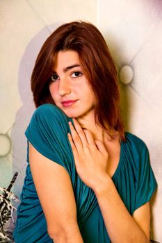 View of a beautiful young girl on a blue dress inside a bar pub.